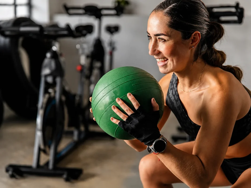 TrainerPro coach guiding a client through a barbell squat