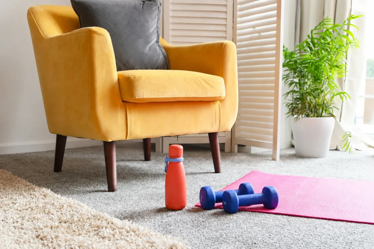 Trainer Pro coach demonstrating a one-arm dumbbell row during an in-home strength session