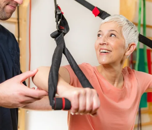 Senior woman exercising with support from a personal trainer